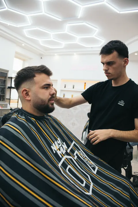 Barber konzultuje úpravu brady s klientom v holičstve 585 BARBER v Nitre